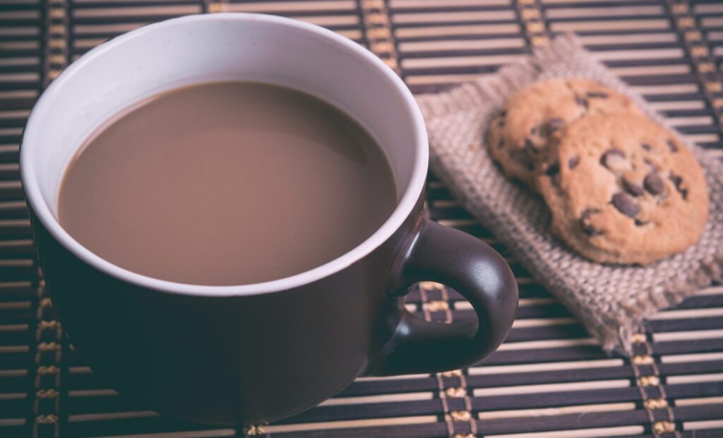 closeup of a cup of coffee and chocolate chip cookies