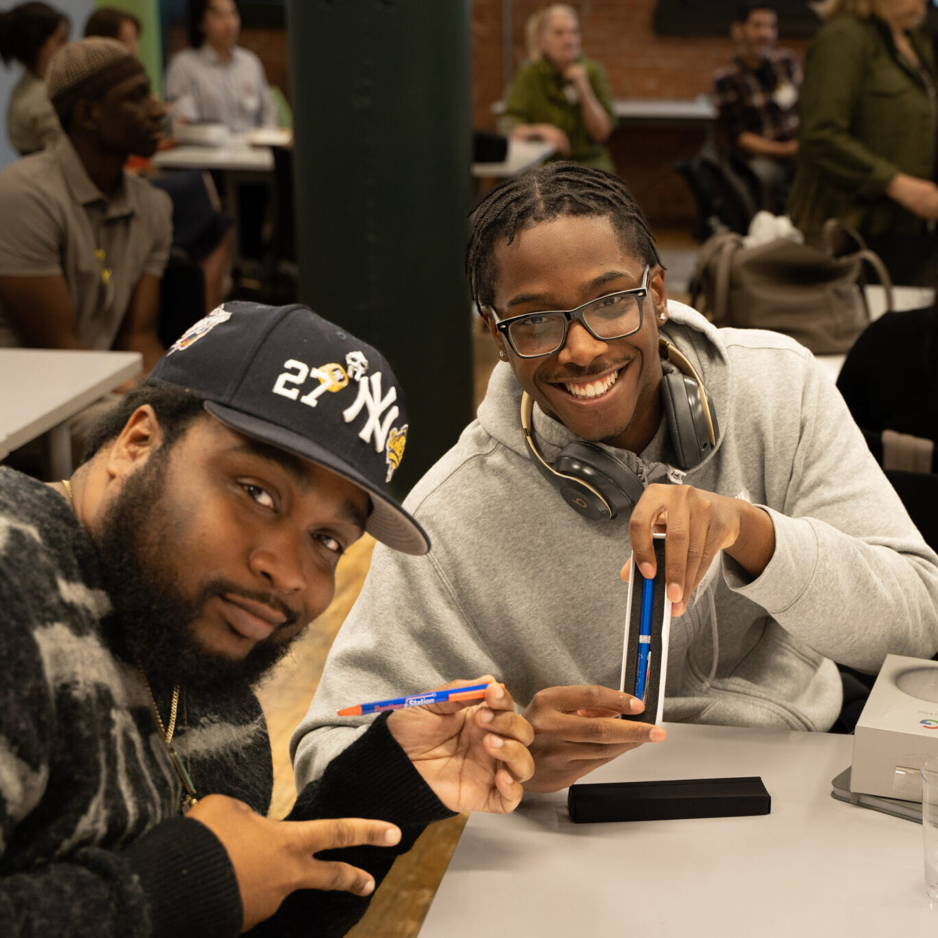Two young men showing swag from Google Field Trip.