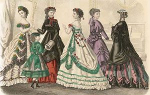 Five ladies and one girl in frilly 19th Century clothing, posed in a drawing room.