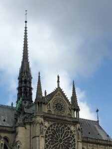 Notre Dame Cathedral spire against blue sky