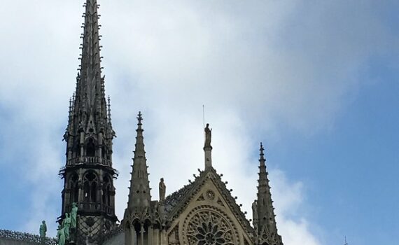 Notre Dame Cathedral spire against blue sky