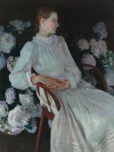 Portrait of woman in white dress among flowers