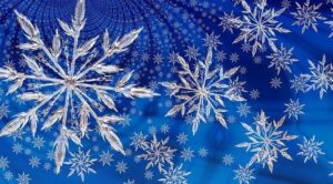 Magnified glittery snowflakes on blue background