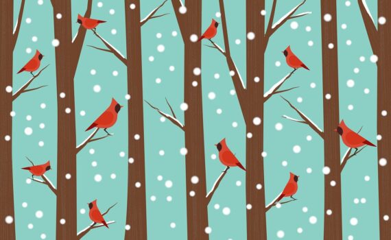 Red cardinals on brown trees with snow-spotted blue background