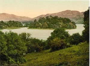 View of Lake Isle of Innisfree with green trees and grass, Sligo, Ireland