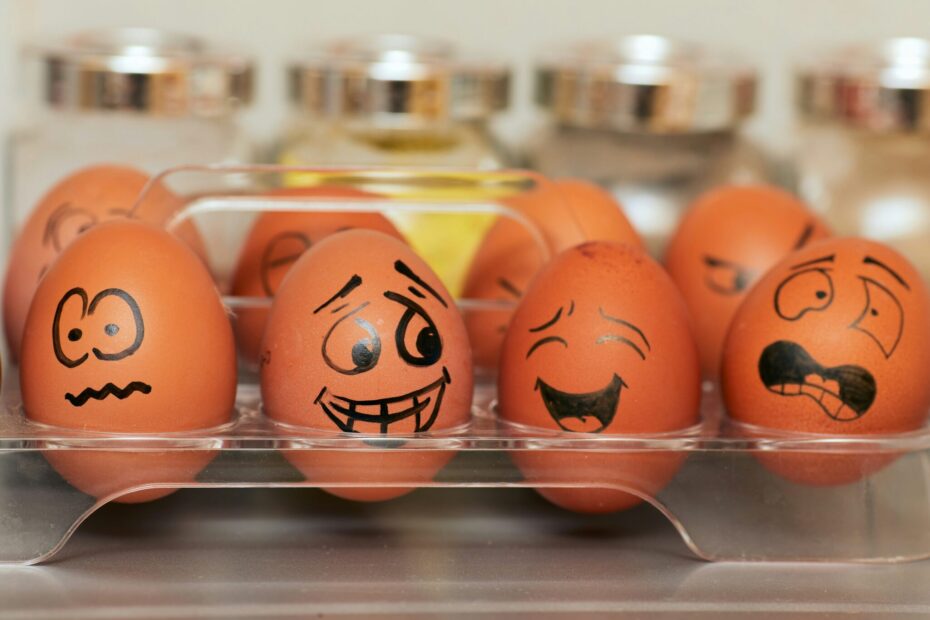 Four brown eggs with faces showing emotions drawn on them.