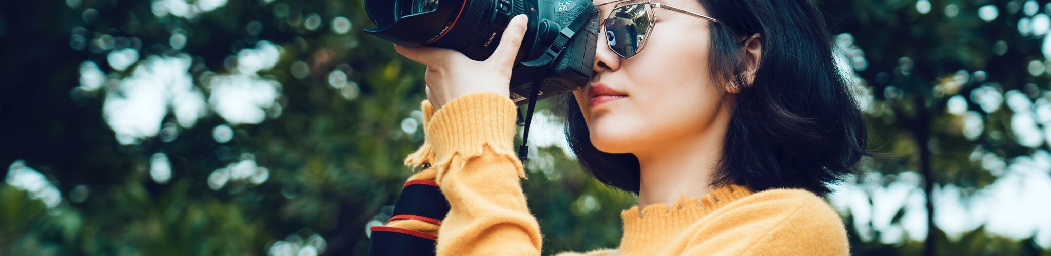 Oriental girl photographing outdoors