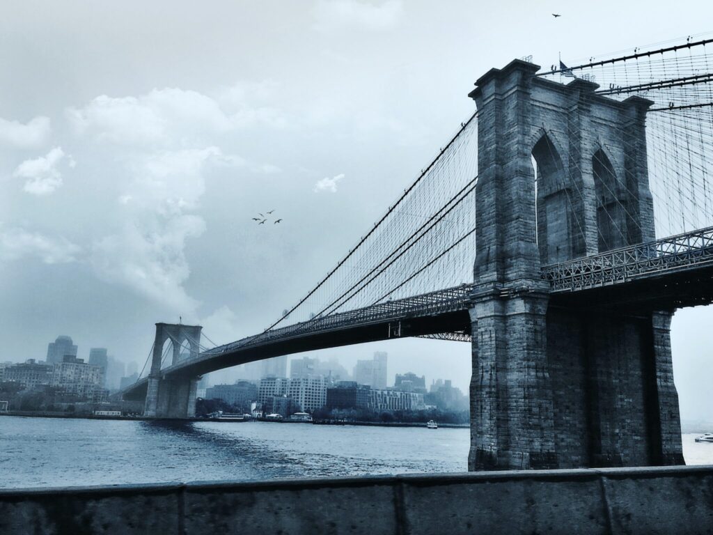 Photo by Joshua Woroniecki: https://www.pexels.com/photo/photo-of-suspension-bridge-under-cloudy-sky-2570208/